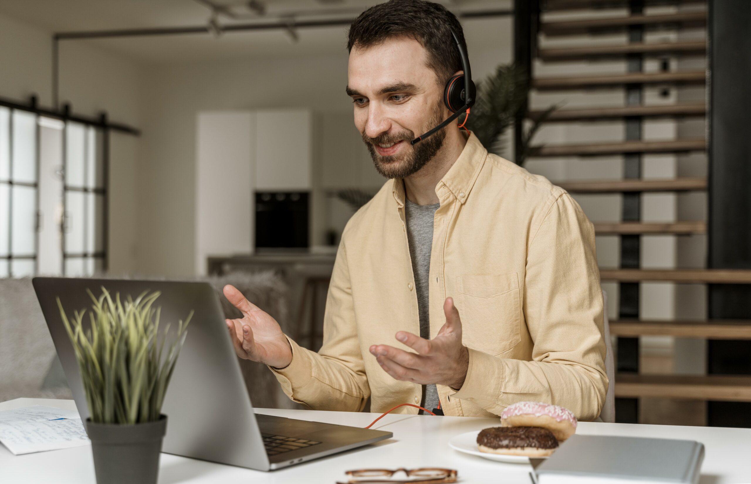 man-with-headset-having-video-call-laptop (1)